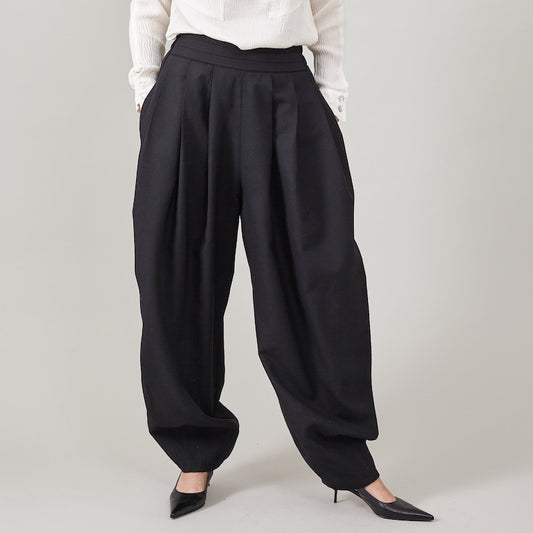 Black wide-leg pants worn by a person on a plain background
