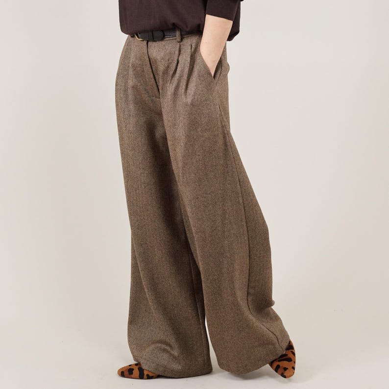 Brown wide-leg pants worn by a person on a beige background