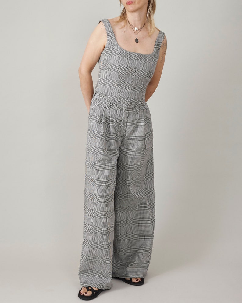 Person wearing a glen plaid bustier top and matching wide leg pants against a plain background