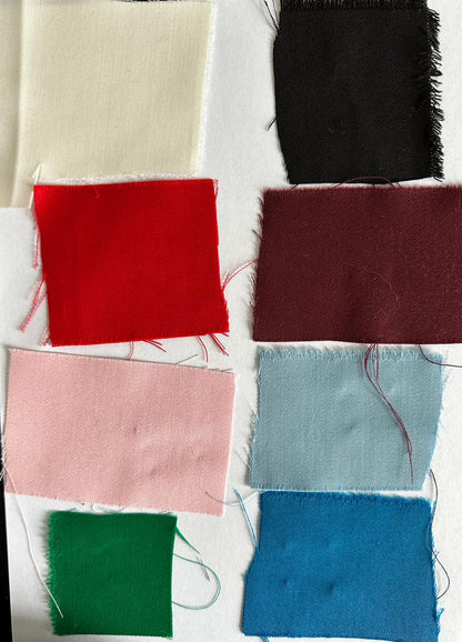 Collection of fabric swatches in various colors on a white background