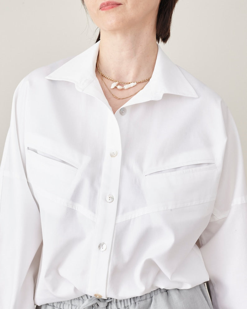 White shirt worn by a person on a plain background