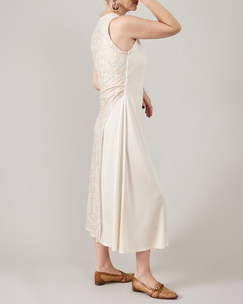 Side view of Fine Thee asymmetric cream silk jersey midi dress, highlighting the rose-patterned floral jacquard back and elegant waist draping.