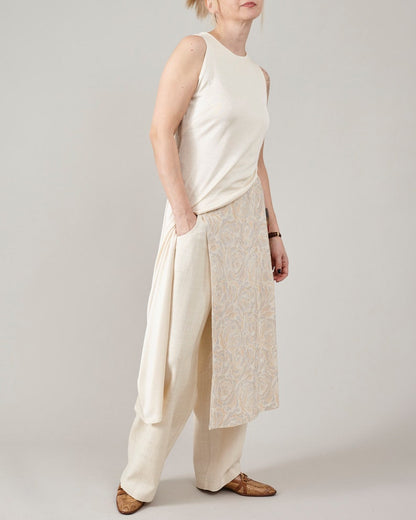 Cream asymmetric silk jersey midi dress styled over off-white flared pants by Fine Thee, luxury silk loungewear look.