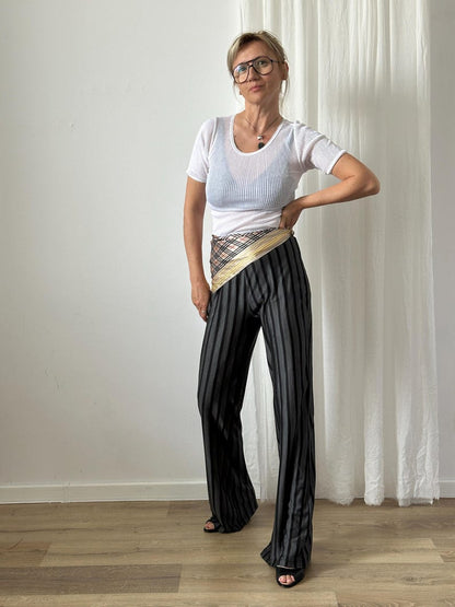 Black striped silk jersey flare pants styled with a white top and silk scarf.