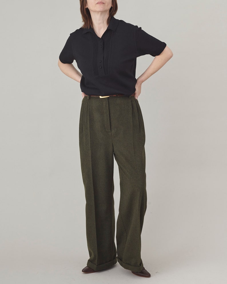 Full-length look with olive cashmere wide-leg pants, black blouse and brown belt.