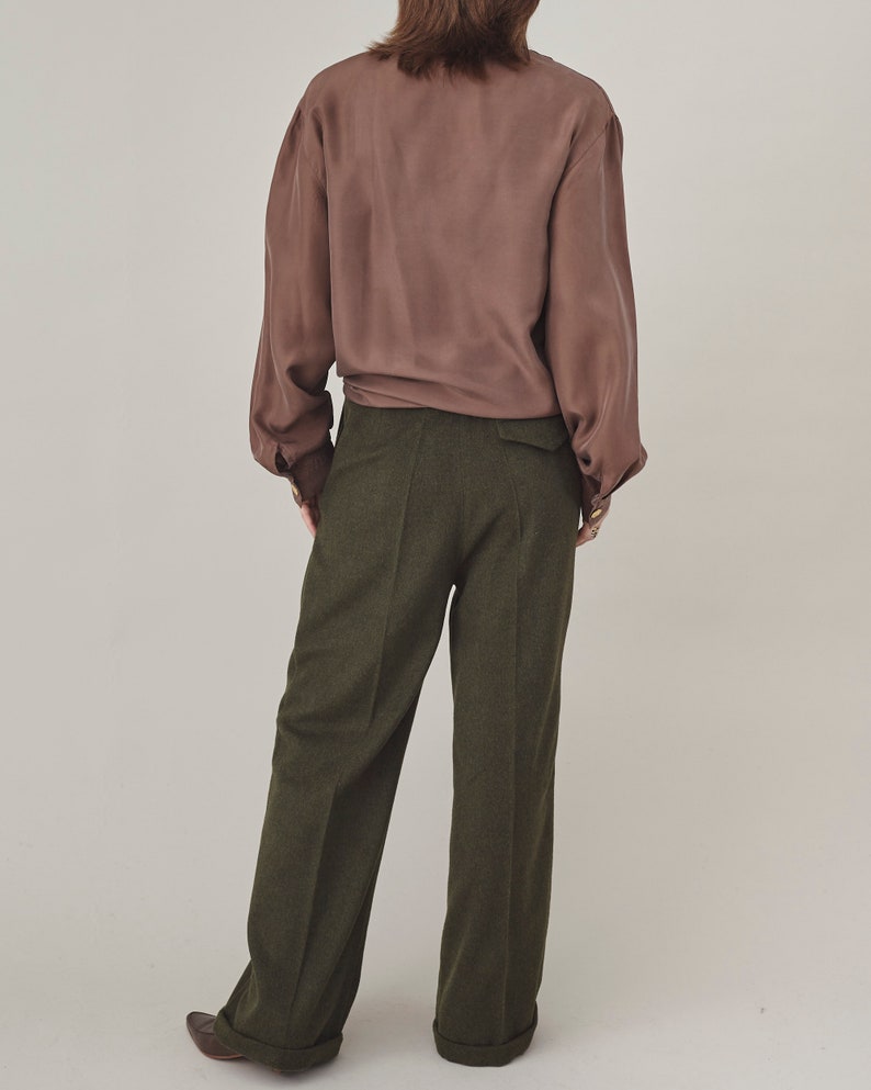 Back view of olive cashmere wide-leg pants styled with a brown silk blouse.