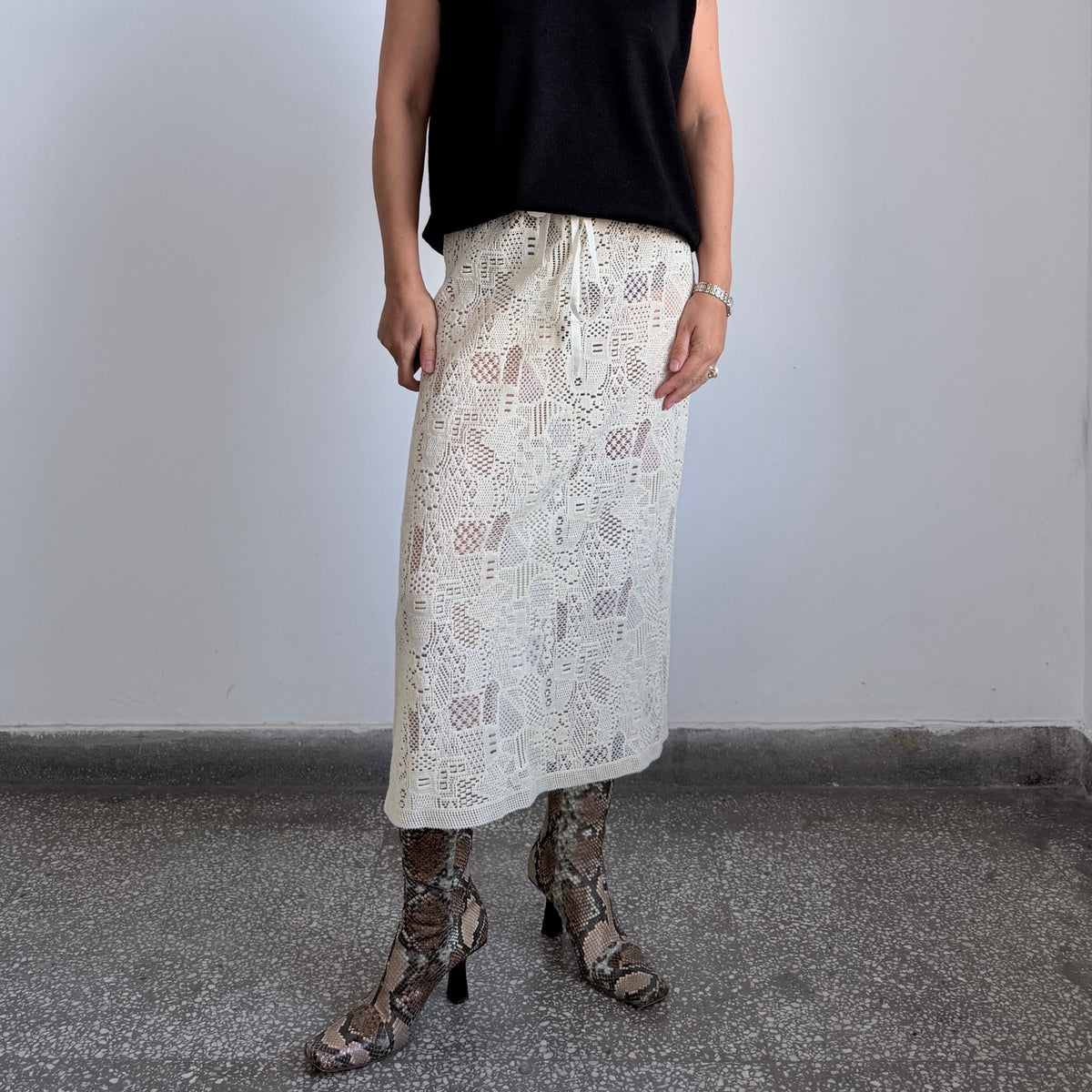 Sheer lace-like cream wool midi skirt side view
