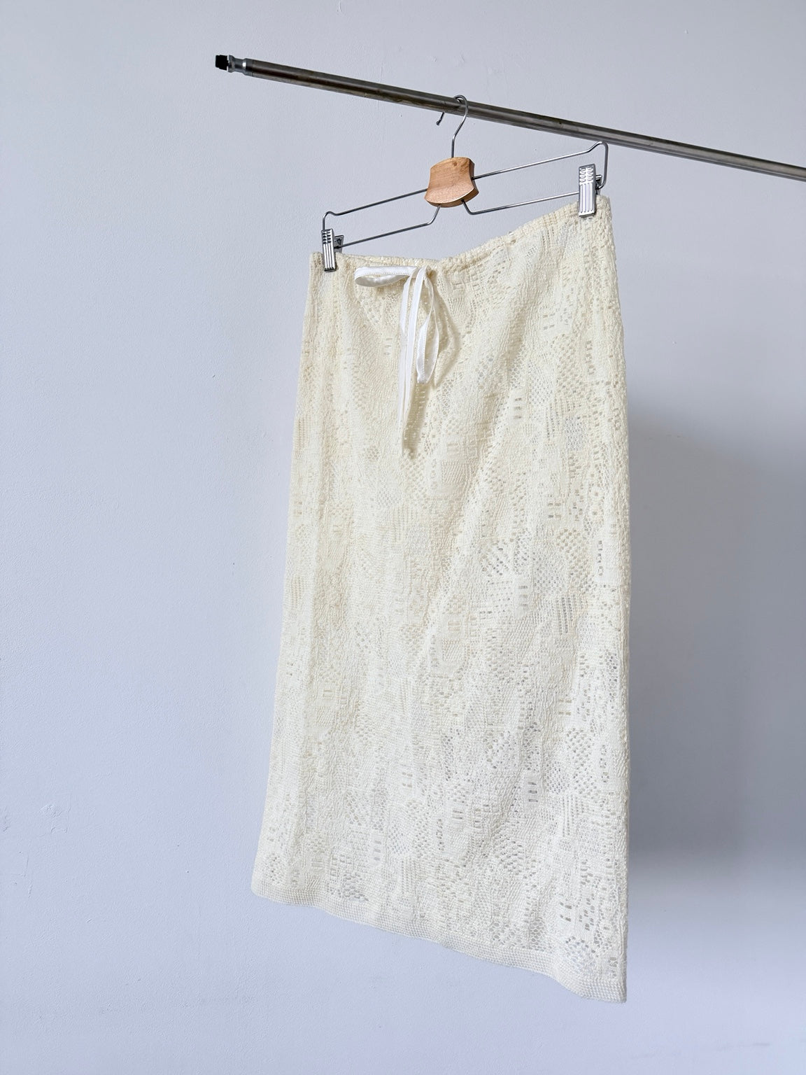 Cream sheer wool drawstring midi skirt hanging front view