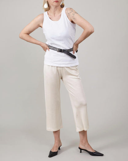 Front view of the ivory cropped version of the silk jersey flare pants.