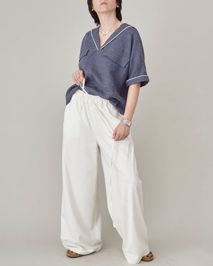 Handmade ivory raw silk wide-leg trousers styled with a navy blue sailor collar linen top by Fine Thee
