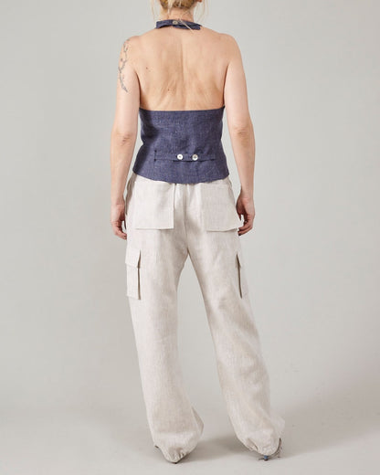 Back view of off-white linen cargo pants showing the relaxed leg and adjustable hems.