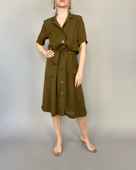 Front view of an olive silk shirt midi dress with short sleeves, button front and tie waist.