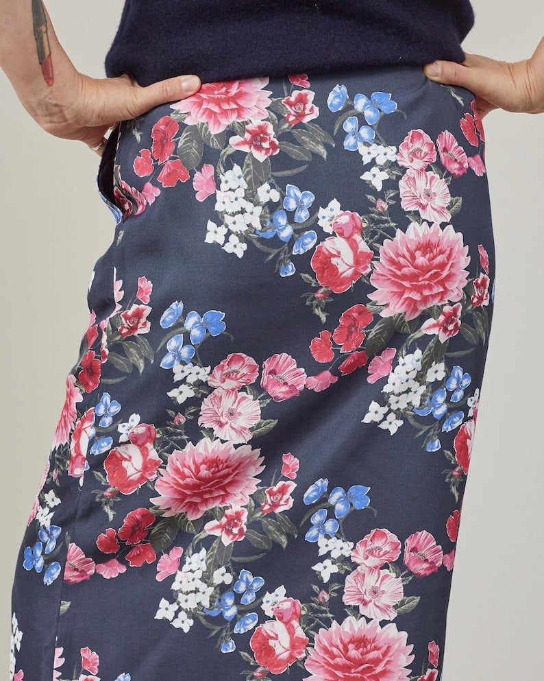 Floral-patterned skirt with pink, red, and blue big flowers on a navy background.