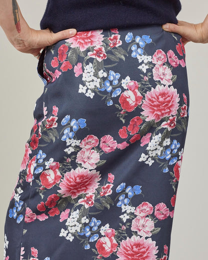 Floral-patterned skirt with pink, red, and blue big flowers on a navy background.