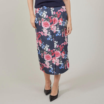 Floral skirt worn by a person on a plain background