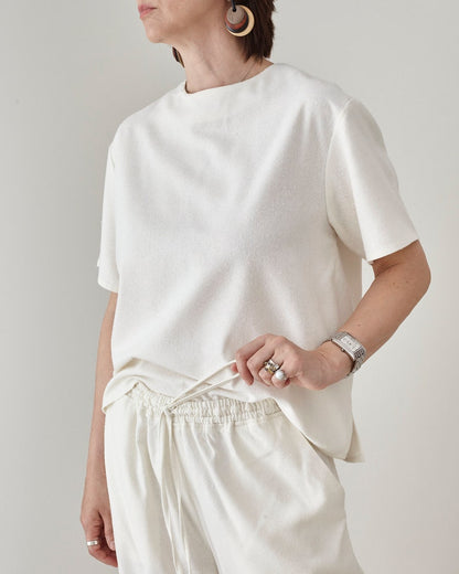 Medium close up view of a premium raw silk lounge outfit featuring a minimalist t-shirt and matching drawstring trousers by Fine Thee