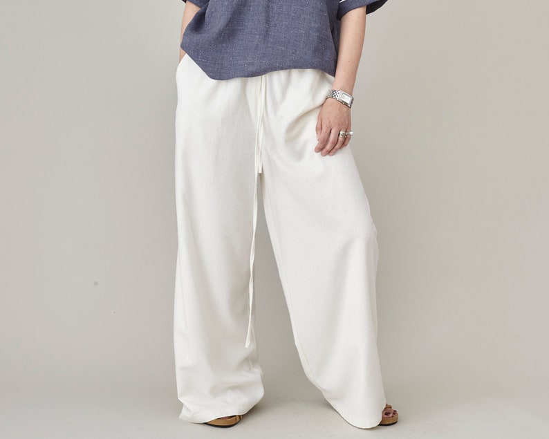 Handmade loose fit raw silk wide leg trousers with long drawstring waist paired with a casual linen top by Fine Thee