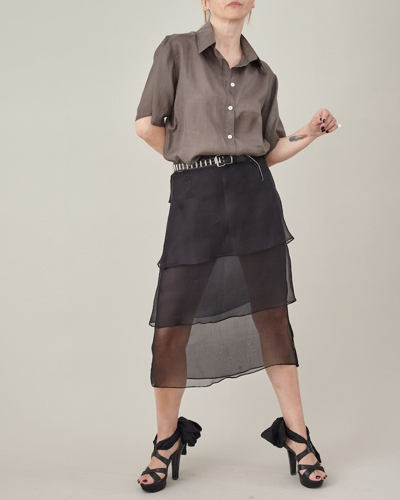 Taupe silk short-sleeve blouse styled with a layered black silk organza skirt.