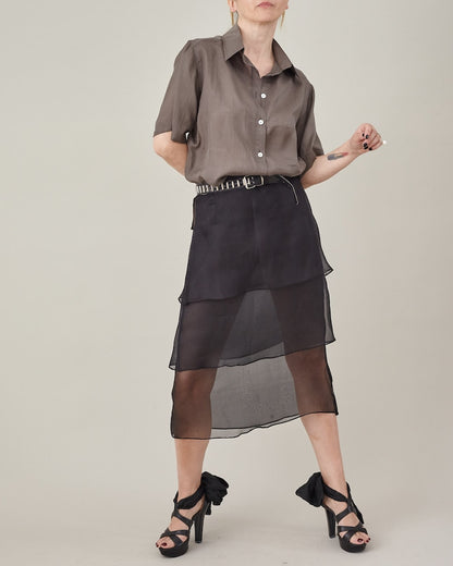 Taupe silk short-sleeve blouse styled with a layered black silk organza skirt.