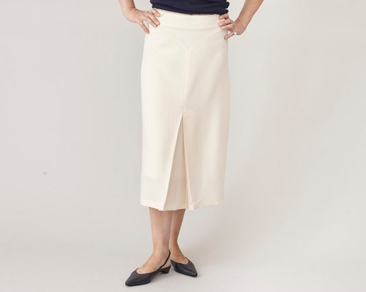 Person wearing a white skirt with a plain background