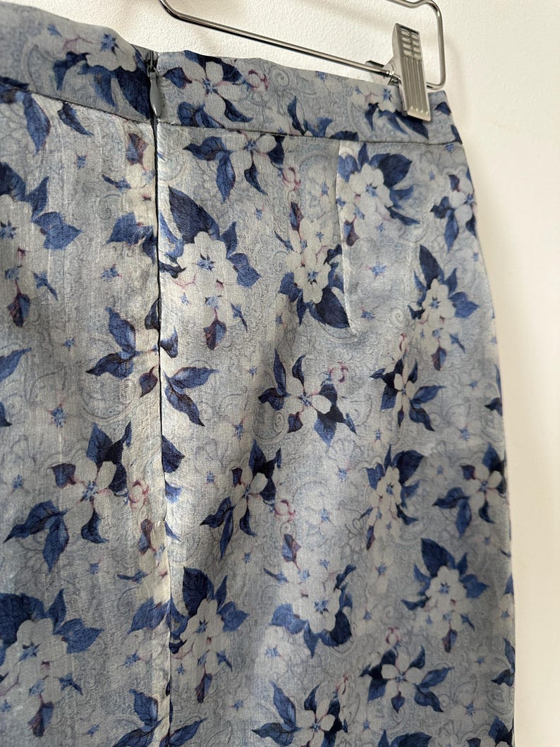 Floral-patterned skirt on a hanger against a white background