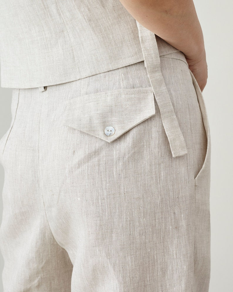 Close-up of beige linen top and pants on a plain background
