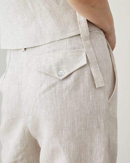 Close-up of beige linen top and pants on a plain background