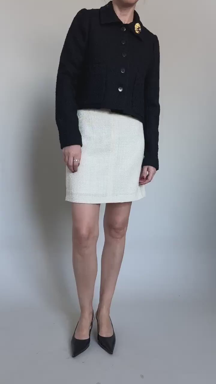 black crop jacket and white mini skirt, both crafted from wool boucle outfit