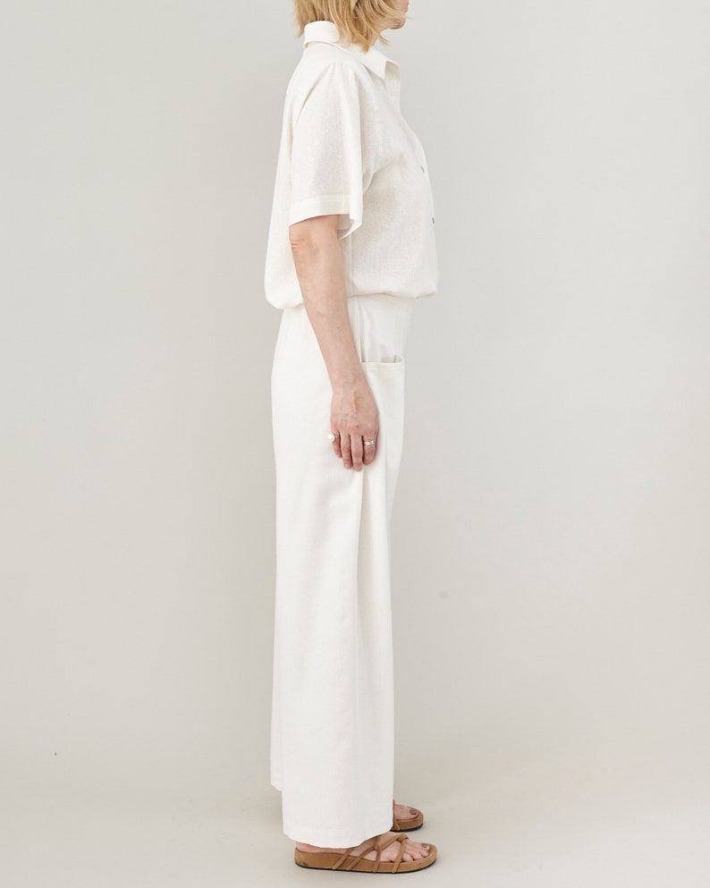 Side profile view of wide-leg raw silk trousers, showing the flattering drape and breathable fabric movement.