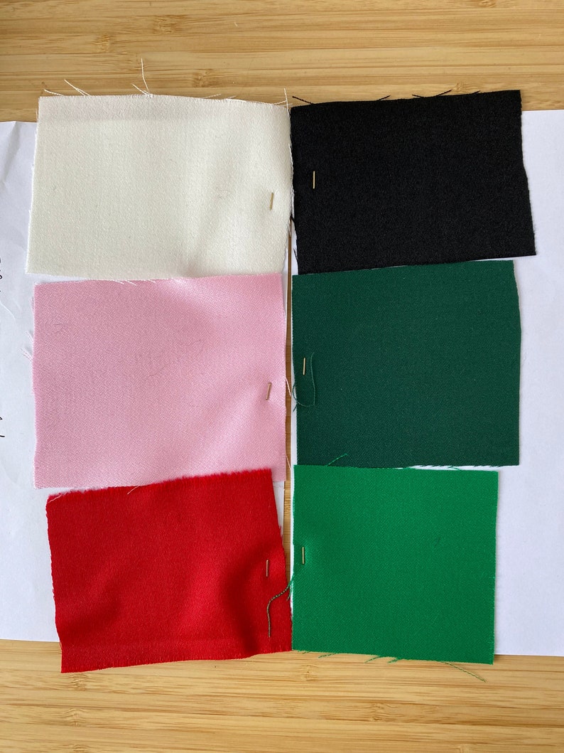 Fabric swatches in white, black, pink, green, and red on a white background.