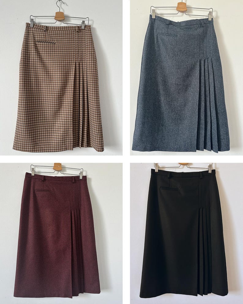 Four skirts in different colors hanging on a white background